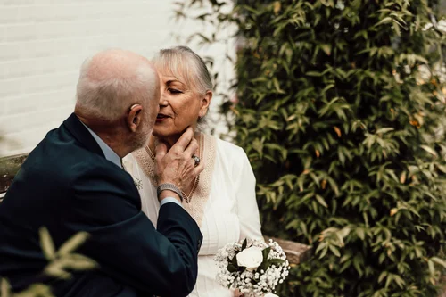 Older couple sharing a tender kiss in the garden
