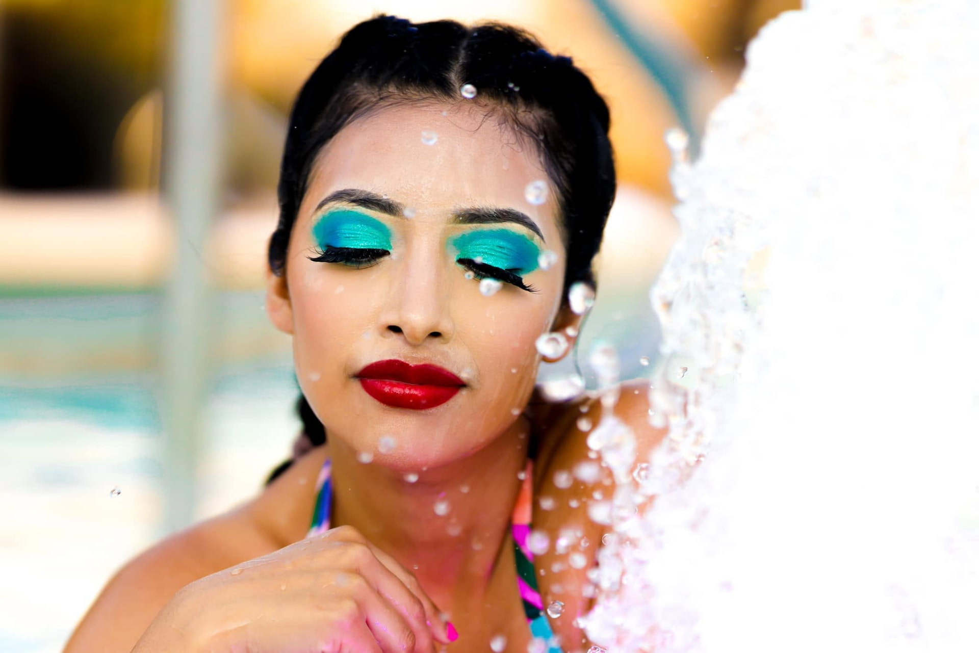 Turquoise eyeshadow and red lips under a splash of water — Editorial lifestyle portrait by Claudia Quiana