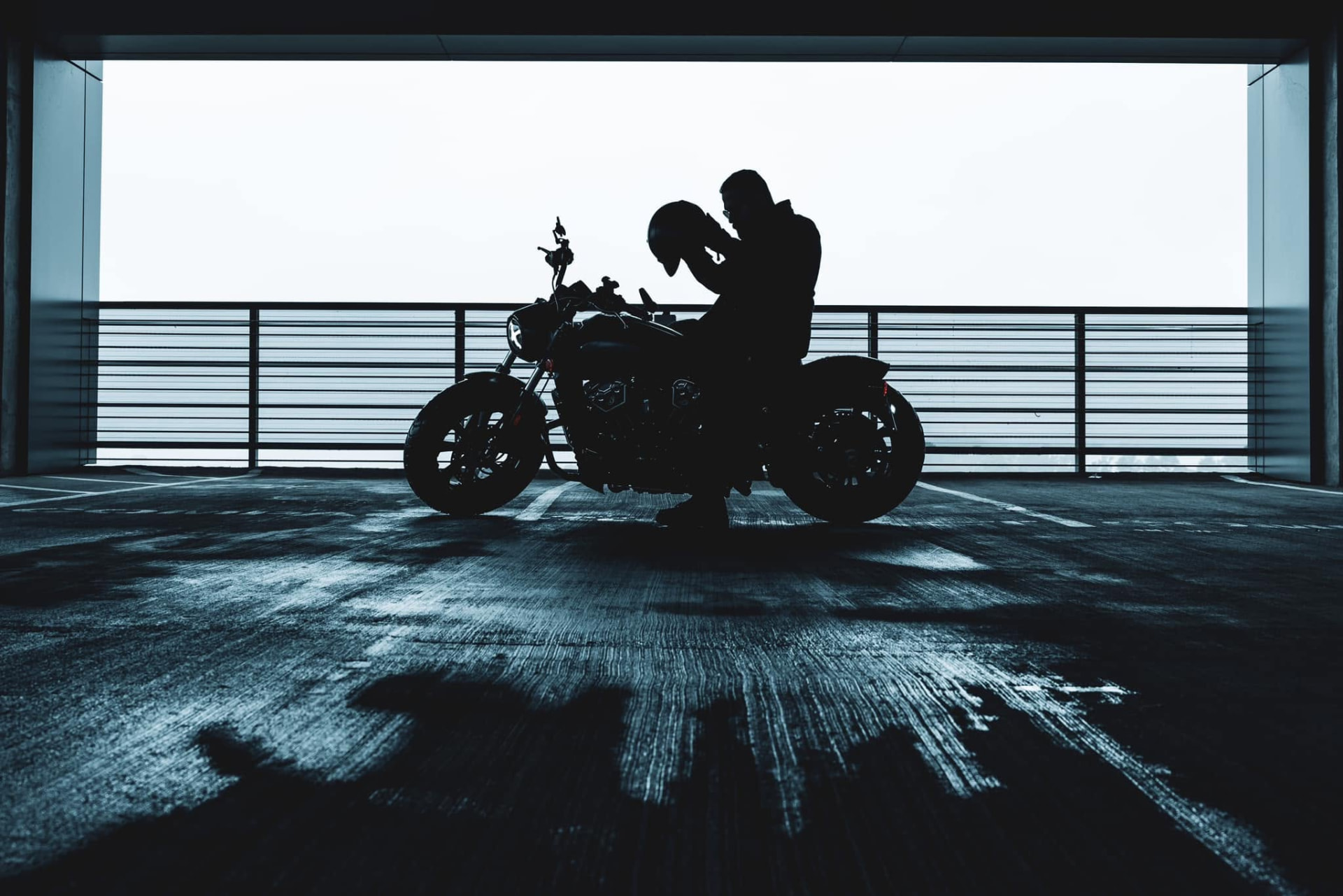 Rider silhouetted on his motorcycle against an open sky