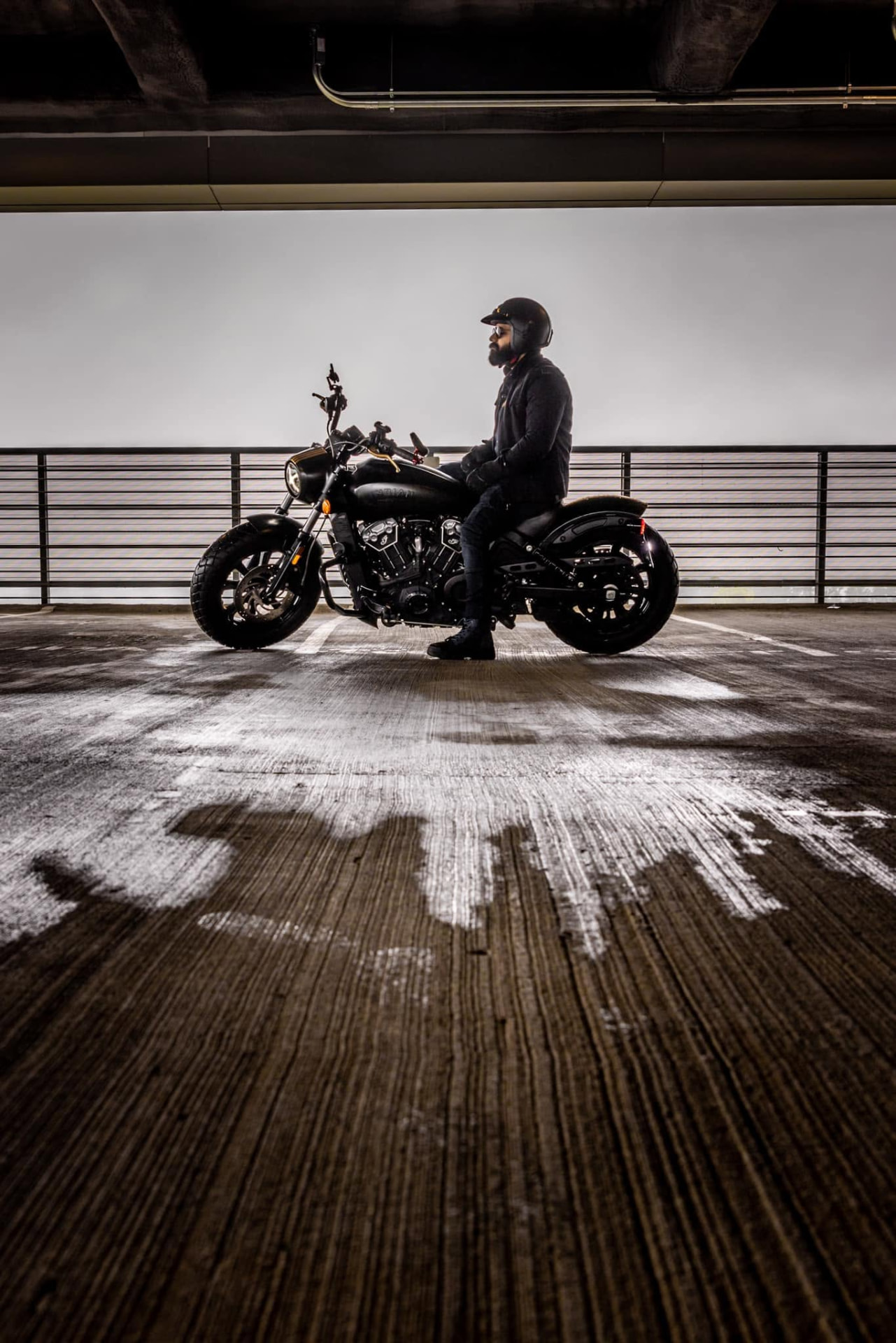 Rider seated on a motorcycle on a rooftop deck
