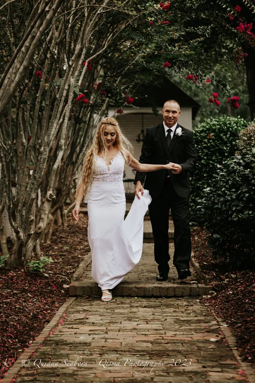 Bride and her father on a brick garden path