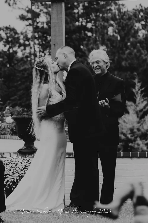 Black and white first kiss before the officiant